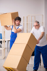 Two male professional movers doing home relocation