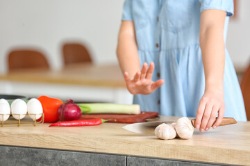 Young woman with food allergy in kitchen