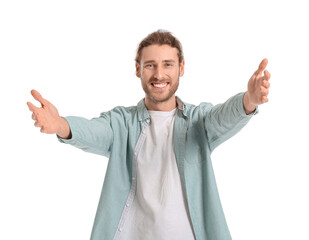 Young man opening arms for hug on white background