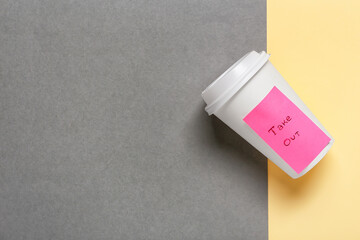 Blank paper cup with text TAKE OUT on color background