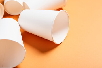 Blank paper cups on color background, closeup