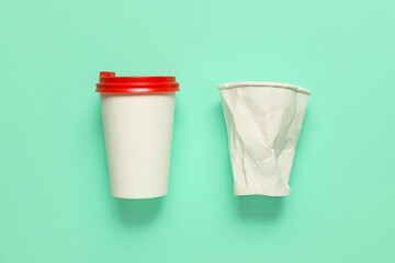 Fototapeta na wymiar Blank paper cups on color background