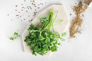 Board with fresh parsley on light background