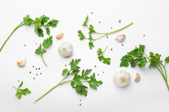 Fresh parsley with garlic on white background