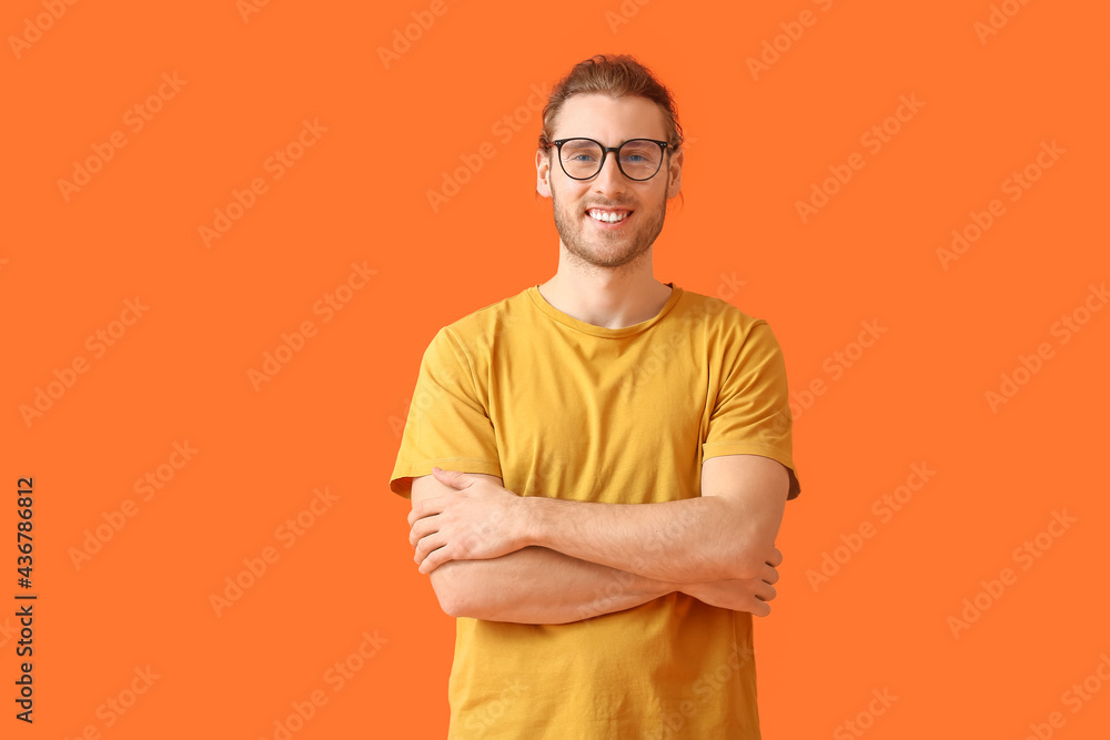 Canvas Prints Young man wearing eyeglasses on color background