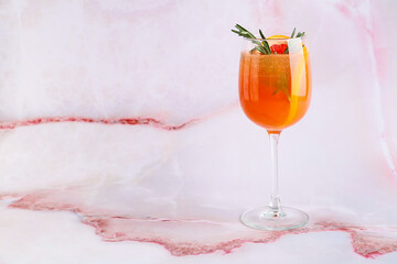 Glass of tasty grapefruit cocktail on light background