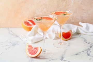 Glasses of tasty grapefruit cocktail on table