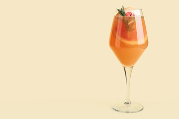 Glass of tasty grapefruit cocktail with rosemary on color background