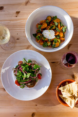 Fresh falafel salad and gnocchi on a table at an outdoor cafe bright cheerful image from above