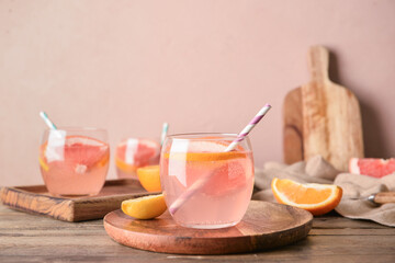 Glasses of tasty lemonade on wooden table