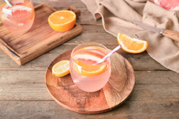 Glasses of tasty lemonade on wooden background