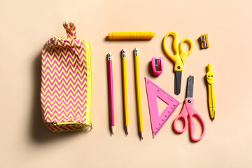 Pencil case and stationery on color background