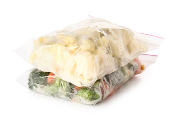 Plastic bags with frozen vegetables on white background
