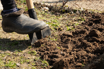 garden processing,leg man digging the ground spring planting.
