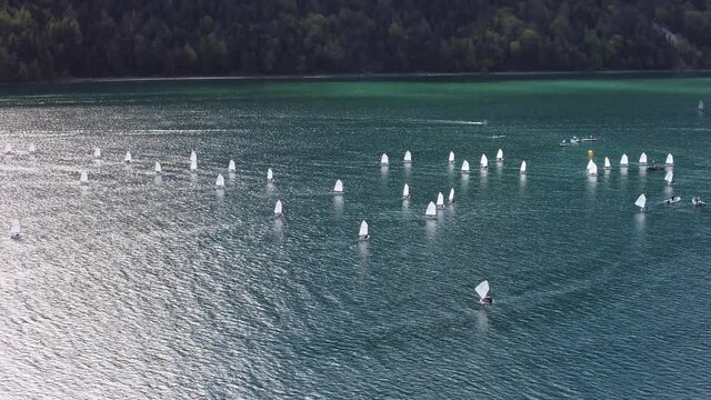 Many little boats on a big, beautiful lake surrounded by big mountains in heart of Alps in Tyrol, Austria.