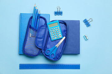 Pencil case and stationery on color background