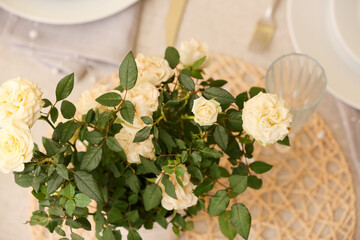 Beautiful white roses in pot on dining table