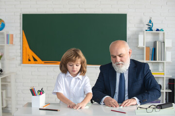 Happy kid in school. Teacher help to learn. Education, teachering, elementary school