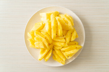 fresh pineapple sliced on plate