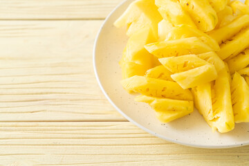 fresh pineapple sliced on plate