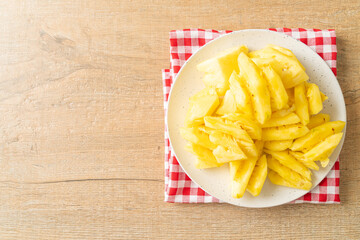 fresh pineapple sliced on plate