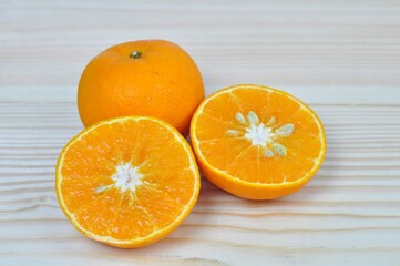 Fresh oranges on wooden background