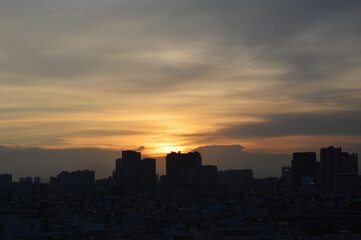 Sunset over Ho Chi Minh city's sky on a cloudy day 