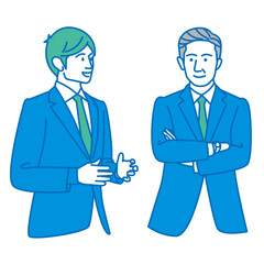 ベテラン社員に相談する若いビジネスマン