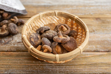 A view of a bamboo basket filled with dried shiitake mushroom chips.