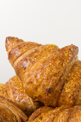  tasty croissants on white background. French food. Close up