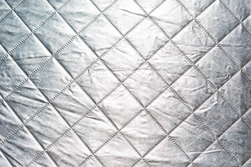 A background view of a silver reflective fabric.