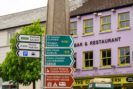 Westport, county Mayo, Ireland - 21.05.2021: Westport, county Mayo, Ireland - 21.05.2021: Sign post in town city center with major routes and places of interest for tourists. Travel directions.