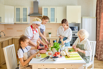 Nice diverse generation family women chopping ingredients for pizza, cooking, enjoying the process of preparing food together, have talk, teach and learn. dinner, holiday, weekend, family concept