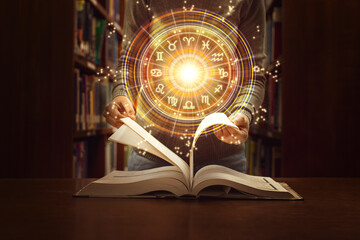 Woman reading a astrology book. Astrological wheel projection, choose a zodiac sign. Trust...