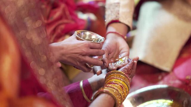 Water poured on Bride & Groom&rsquo;s hand at Indian wedding ceremony. Traditions of Indian marriage. 