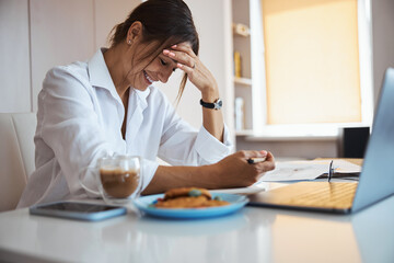 Cheerful woman working on business project in office