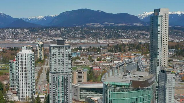 Beautiful drone view of Vancouver's North Shore Mountains in HD from Surrey City Centre on a sunny summer day in British Columbia Canada