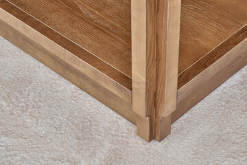 Furniture set of veneer and solid ash timber with acryl stone countertop with figure edge in summer kitchen on open terrace close view