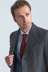 portrait of a handsome businessman fixing his coat