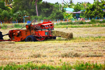 the balers , farmer using balers keep straw after harvest