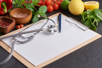 Fresh fruits and vegetables for background, Different fruits and vegetables for eating healthy, Colorful fruits and vegetables. top view of blank clipboard with pen near stethoscope.