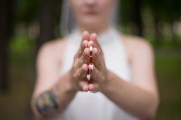 bride holding wedding rings with round plan
