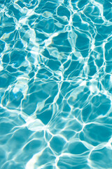 Fototapeta premium Ripped water in swimming pool. Surface of blue swimming pool, background of water.