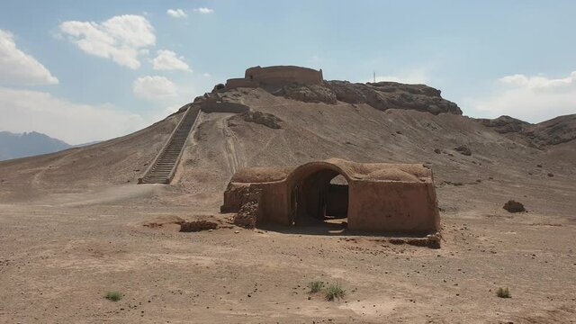 Yazd, Iran - May 2019: Tourist walking inside ruins of Zoroastrians Dakhmeh Towers of Silence in Yazd city