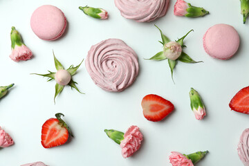 Concept of tasty macaroons and marshmallows on white background