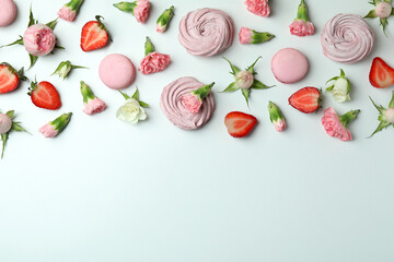 Concept of tasty macaroons and marshmallows on white background