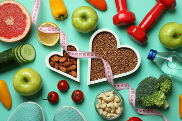 Different healthy lifestyle accessories on mint background