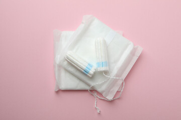 Sanitary pads and tampons on pink background