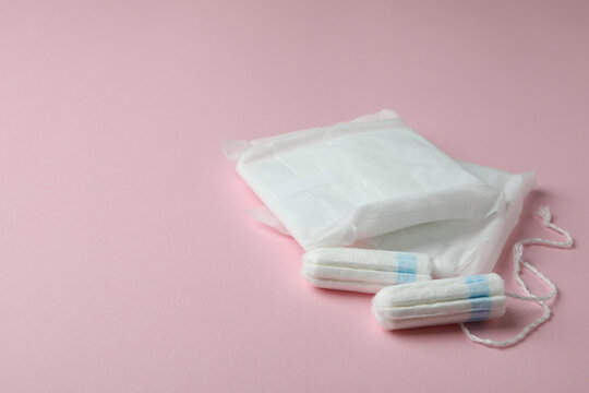 Sanitary pads and tampons on pink background