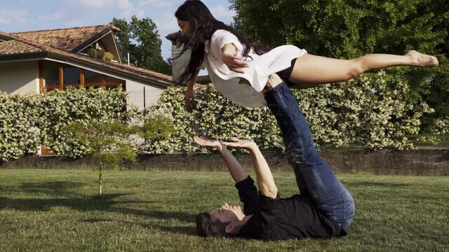 Modern dancers practicing front bird in summer garden